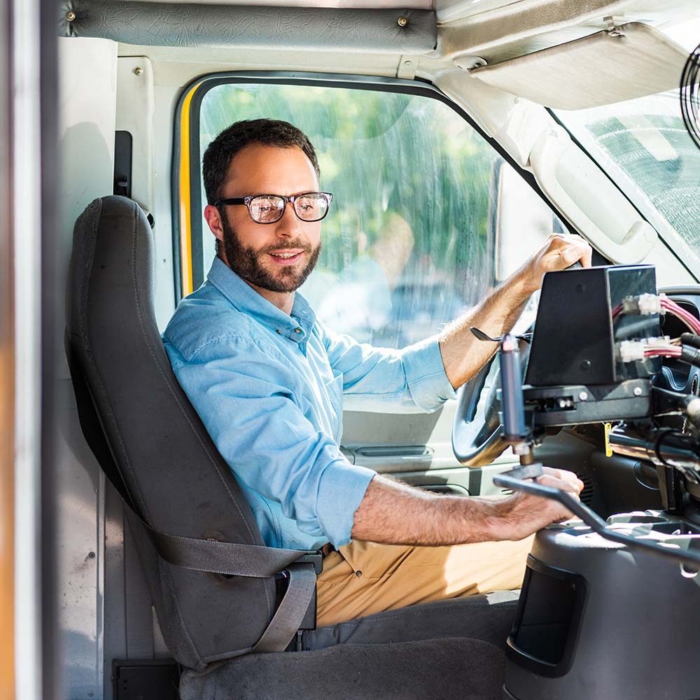 school-bus-driver-sitting-inside-bus-and-pulling-l-9XMSMYV.jpg